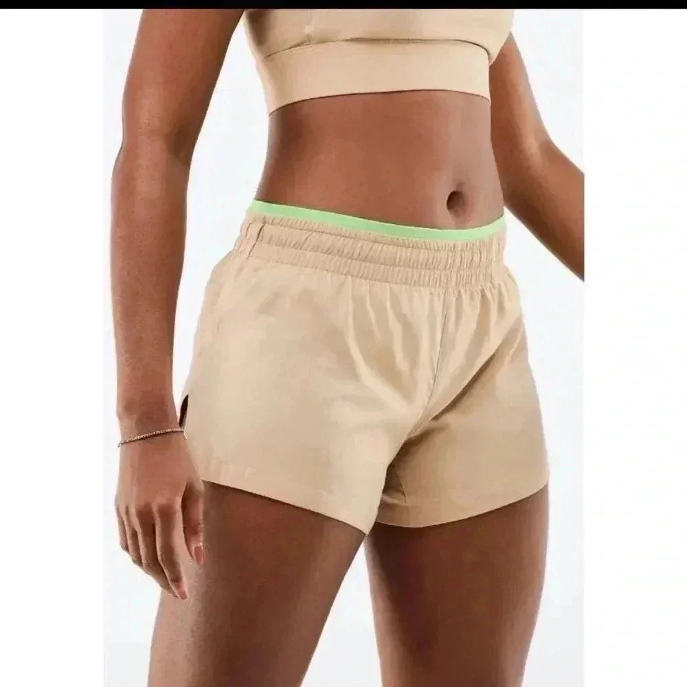 Fabletics women’s beige and green mid rise running shorts size medium